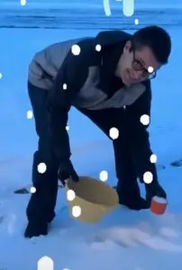 My husband collecting fresh snow in a snowstorm for our protein powder snow ice cream dessert.